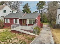 Charming red home with a ramp leading to the front door and a well-maintained lawn at 1114 Adams St, Decatur, GA 30030