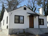 Charming exterior of home with wood siding, black window frames and inviting front entrance at 951 Lawton Sw St, Atlanta, GA 30310