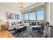 Bright living room featuring large windows with city views, a comfortable sofa, and stylish decor at 3630 Peachtree Ne Rd # 2305, Atlanta, GA 30326