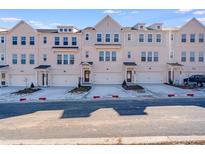 Charming townhomes featuring brick and siding accents, private garages, and beautifully landscaped surroundings at 3267 Durston Ct, Dacula, GA 30019