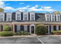 Brick townhouse exterior with gray roof and landscaping at 11 Newport Nw Pl, Atlanta, GA 30318