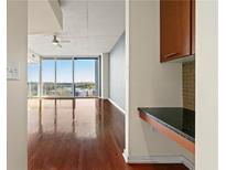 Bright living room with hardwood floors and city views at 3300 Windy Ridge Se Pkwy # 1120, Atlanta, GA 30339