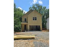 New home exterior with unfinished yard and visible wood construction at 1664 Crestridge Se Dr, Marietta, GA 30067
