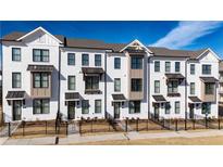 New townhome construction featuring painted brick, black window frames, and matching awnings over the entries at 516 Healy Dr # 69, Cumming, GA 30040