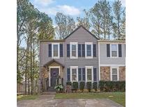 Two-story townhome with gray siding, black shutters, and a landscaped yard at 361 W Post Oak Sw Xing, Marietta, GA 30008