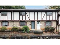Charming brick townhouse featuring Tudor-style details and a well-maintained front yard with mature landscaping at 2946 N Dekalb Dr # Apt C, Atlanta, GA 30340