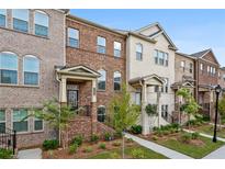 Brick townhouses with landscaping and sidewalk at 3306 Main St, Duluth, GA 30096