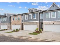 Three similar townhouses with attached garages and landscaping at 1068 Rose Dr, Marietta, GA 30060