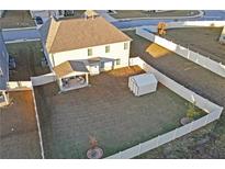 A spacious backyard with a well-maintained lawn, shed, privacy fence and covered patio area perfect for outdoor entertaining at 189 Osier Dr, Mcdonough, GA 30252