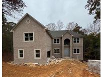 Two-story brick home with attached garage and landscaping at 4251 Matisse Ln, Fairburn, GA 30213