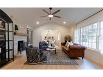 Spacious living room features a fireplace, hardwood floors, and comfortable seating at 13130 Providence Rd, Milton, GA 30009