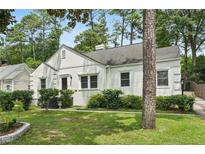 Charming single-story white home with a well-maintained lawn and mature trees offering great curb appeal at 952 Lindbergh Ne Dr, Atlanta, GA 30324