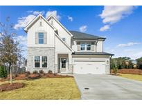 Two-story farmhouse-style home with stone accents and a three-car garage at 4480 Beechnut Cir, Cumming, GA 30028