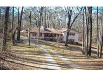 Ranch home nestled in a wooded lot with a long driveway at 6656 Mitchell Sw Ln, Mableton, GA 30126