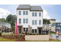 New construction townhouse with white siding, black trim, and a brick base offers modern living at 365 Skylar Se Way, Atlanta, GA 30315