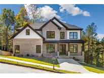 Charming two-story brick home with black trim, crisp white accents, and a well-manicured lawn at 5610 Bent Grass Way, Douglasville, GA 30135