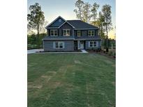 Charming two-story home with manicured front yard and landscape at 3030 Fairway Dr, Villa Rica, GA 30180