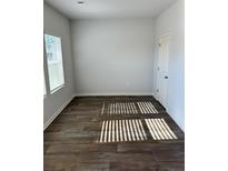 Bright bedroom featuring wood-look floors, and a light-filled window at 504 Overlook Rd, Covington, GA 30052