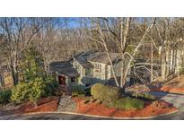 Charming home boasts mature landscaping, a stone walkway and colorful foliage at 355 N Peak Dr, Alpharetta, GA 30022