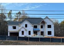 Two-story house under construction, gray roof, large windows, and a covered porch at 4292 Sardis Church Rd, Buford, GA 30519