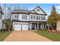 Two-story home with gray shutters, three-car garage, and manicured lawn at 1010 Coleman Place Dr, Roswell, GA 30075