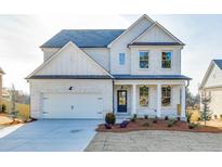 Two-story white brick home with gray roof and landscaping at 2870 S Waterworks Rd, Buford, GA 30518