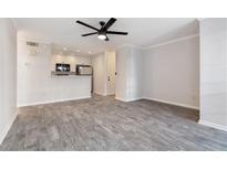 Open-concept living room featuring hardwood floors, a ceiling fan and combined kitchen at 201 Granville Ct, Atlanta, GA 30328