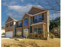 Brick two-story house with attached garage and landscaping at 3554 Umatilla Sw Ln, South Fulton, GA 30331