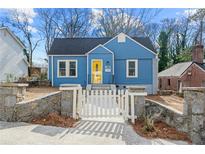 Charming blue house with white picket fence and stone accents at 1196 Oleander Nw St, Atlanta, GA 30314