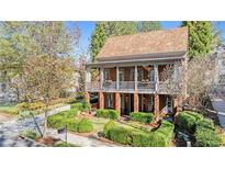 Brick two-story home with a front porch and well-manicured landscaping at 6220 Vickery Creek Rd, Cumming, GA 30040