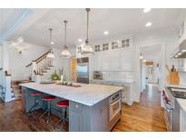 Spacious kitchen with island, stainless steel appliances, and hardwood floors at 6830 Vickery Creek Rd, Cumming, GA 30040