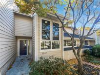 Exterior shot of a two-story home with large windows and a well-maintained front yard at 2007 Variations Ne Dr, Atlanta, GA 30329