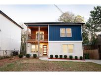 Two-story home with blue and white siding, balcony, and landscaped yard at 1330 Lockwood Sw Dr, Atlanta, GA 30311