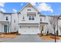 White two-story home with a two-car garage and landscaping at 625 Skytop Dr, Cumming, GA 30040