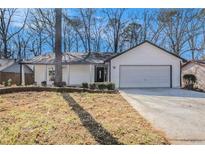 Charming single-story home featuring a freshly painted exterior and well-maintained landscaping at 1312 Buttercup Ct, Lawrenceville, GA 30044