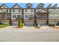 Charming townhomes featuring individual garages and covered porches in a well-maintained community at 678 Emeril Dr, Avondale Estates, GA 30002