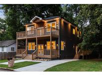 Beautiful two-story home with a lovely front yard and inviting wooden balconies on both levels at 60 Newcastle Sw St, Atlanta, GA 30314