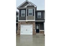 Two-story townhome featuring a one car garage and neutral color scheme at 241 Ivey Ter # 42, Temple, GA 30179
