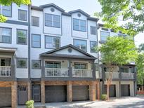 Inviting townhome with a charming covered balcony and attached garages for convenient parking at 221 Semel Nw Cir # 273, Atlanta, GA 30309