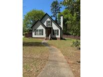 Charming home with a gabled roof, black shutters, and a walkway leading to the front door at 333 Pickfair Sw Way, Atlanta, GA 30315