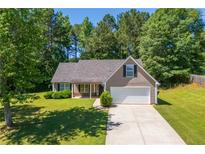 Charming single-Gathering home with a well-manicured lawn and attached two car garage in a wooded neighborhood at 90 Loudoun Dr, Covington, GA 30014