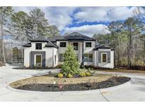 Stunning two-story home with a circular driveway and professionally landscaped front yard at 4090 Sandy Lake Dr, Stonecrest, GA 30038