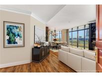 Sun-filled living room and dining area with beautiful hardwood floors and elegant chandelier at 750 Park Ne Ave # 8E, Atlanta, GA 30326