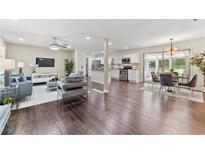 Open concept living area with hardwood floors, modern furniture, and a view into the kitchen at 3263 Dodson Dr, Atlanta, GA 30344