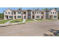 Charming townhomes with manicured lawns and elegant brick facades provide curb appeal at 161 Brush Creek Ct, Stockbridge, GA 30281