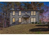 Two-story home with a covered entrance and professionally landscaped front yard at 508 Sutters Mill Rd, Stone Mountain, GA 30087