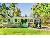 Charming ranch home with a spacious green lawn and covered front porch at 3020 Parkridge Ne Dr, Atlanta, GA 30319