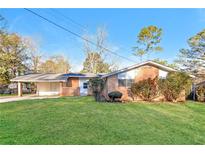 Brick ranch house with carport and well-maintained lawn at 3762 Elkridge Dr, Decatur, GA 30032