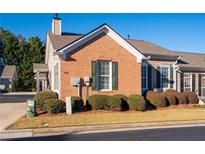 Charming brick home featuring manicured landscaping, a new roof, and beautiful architectural details at 778 Camry Cir, Dallas, GA 30157