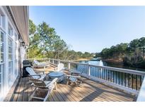 Inviting deck features a grill, several chairs, and a great view of the lake and water feature at 6191 Talmadge Run, Acworth, GA 30101